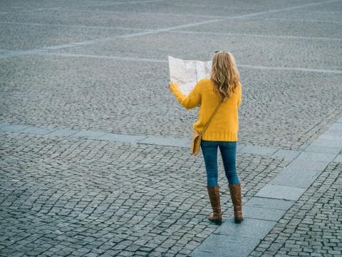 Woman finding her way with a map