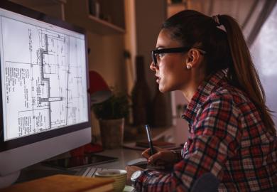 Architect, studying a house plan on her computer