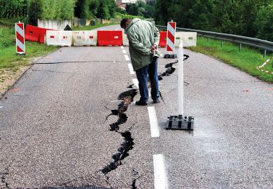  Passer by looking at cracks in the road  near Contz-les-Bains, Lorraine, France to illustrate Paris-Saclay crisis exposes cracks in mega-university project