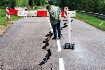  Passer by looking at cracks in the road  near Contz-les-Bains, Lorraine, France to illustrate Paris-Saclay crisis exposes cracks in mega-university project